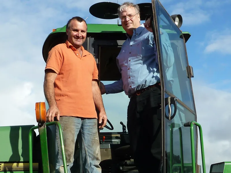 Farmer and adviser discussing farm business plans on a tractor